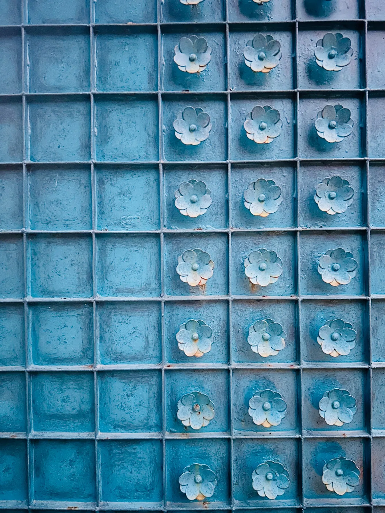 Blue ceramic panels with floral relief details at Devasom, Kolkata
