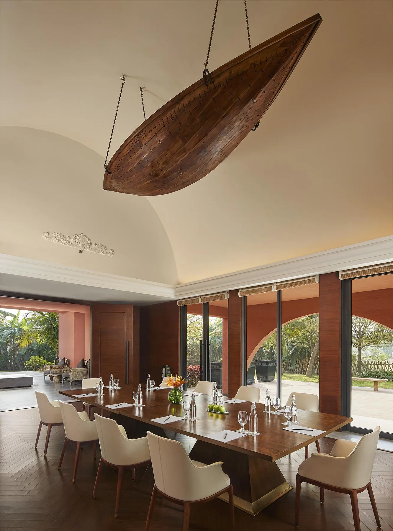 Dining space with a suspended wooden boat installation at Devasom