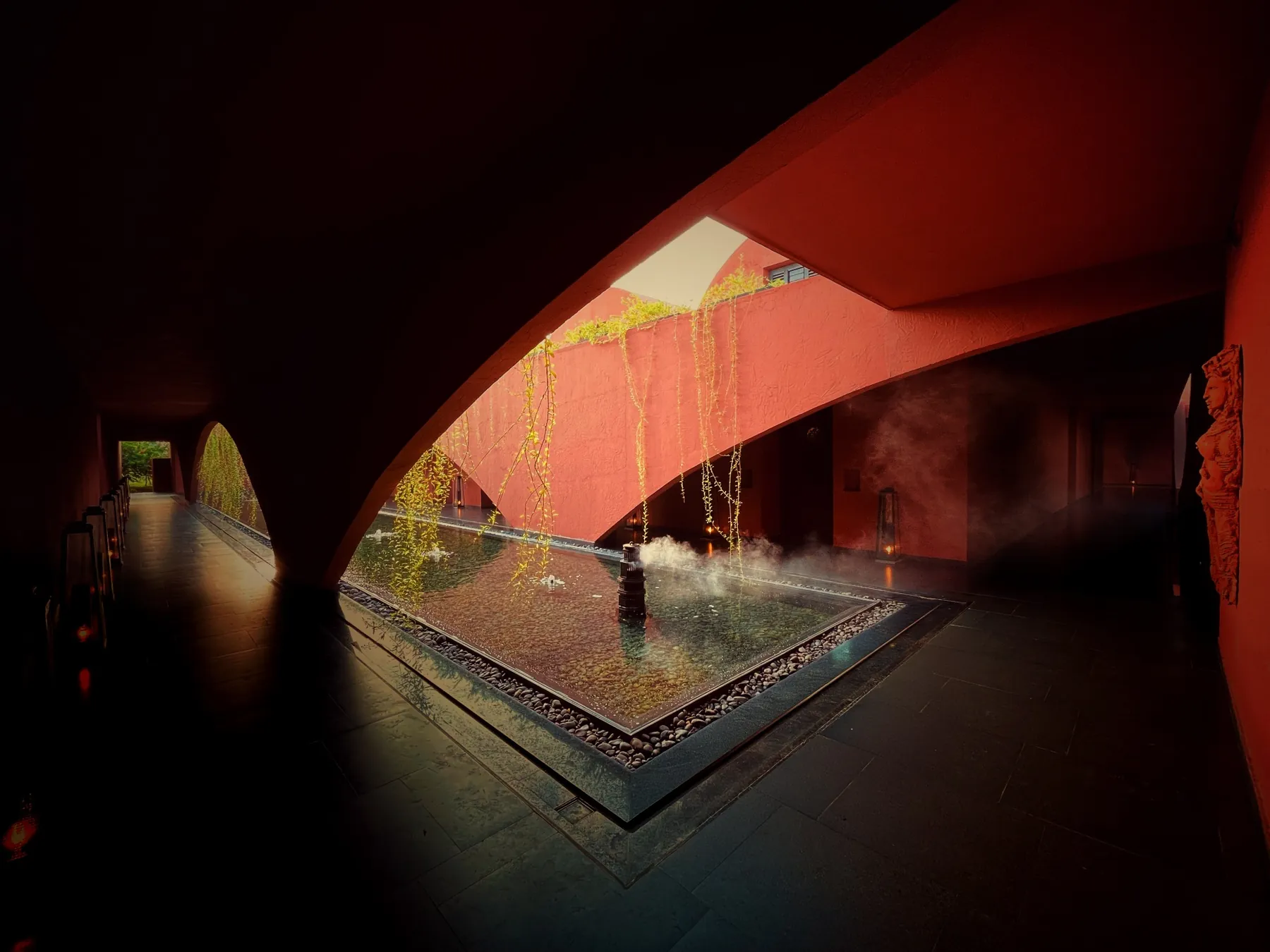 Interior view of an angular skylit water court at Devasom