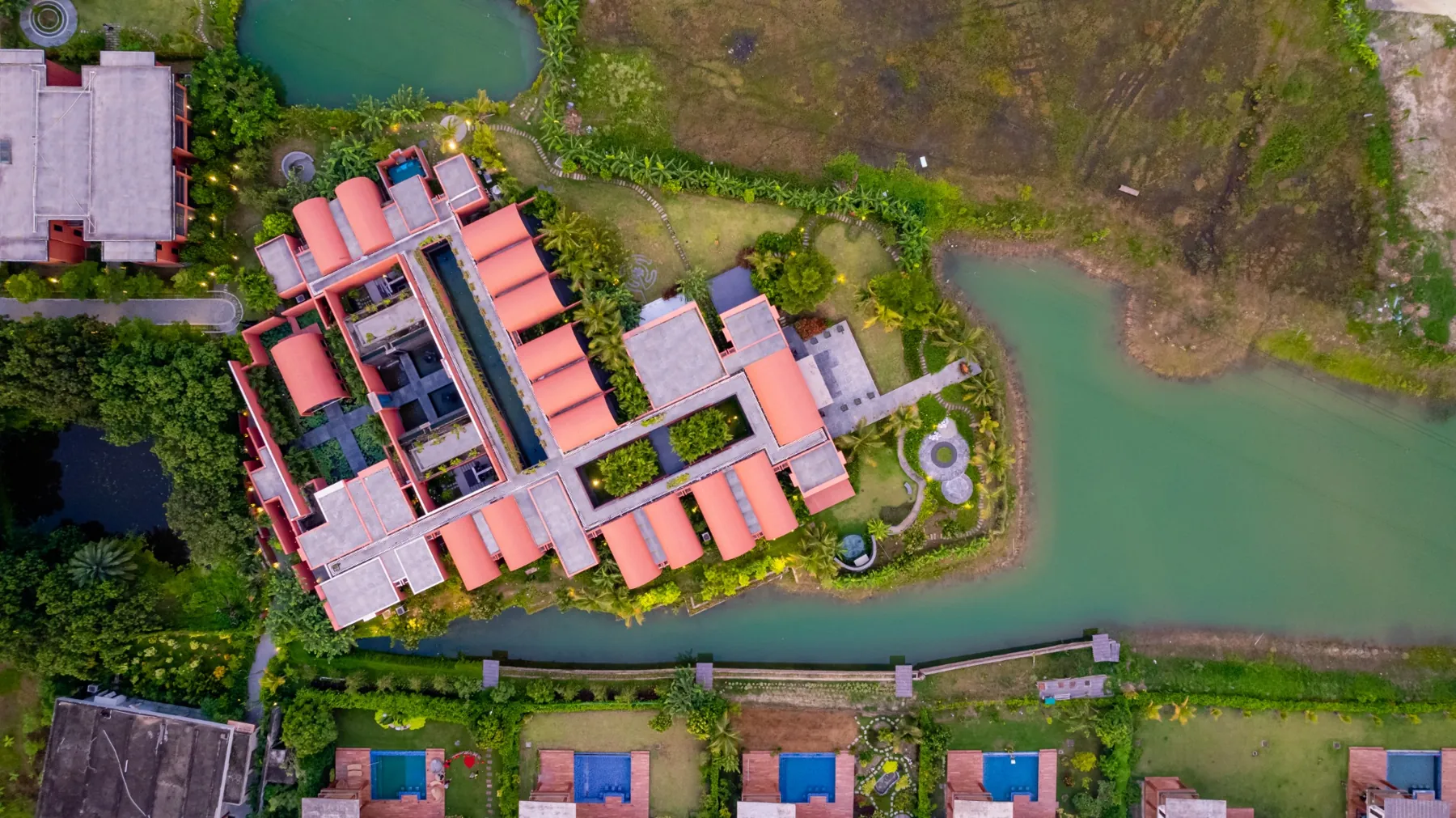 Overhead view of Devasom wellness retreat surrounded by water and planting