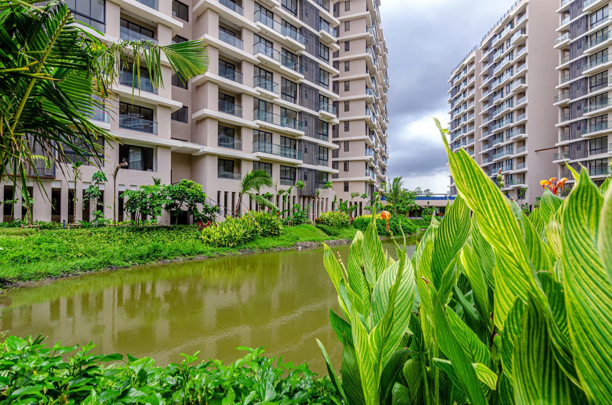 Jiva Homes balconies and residential facades above the planted lake edge