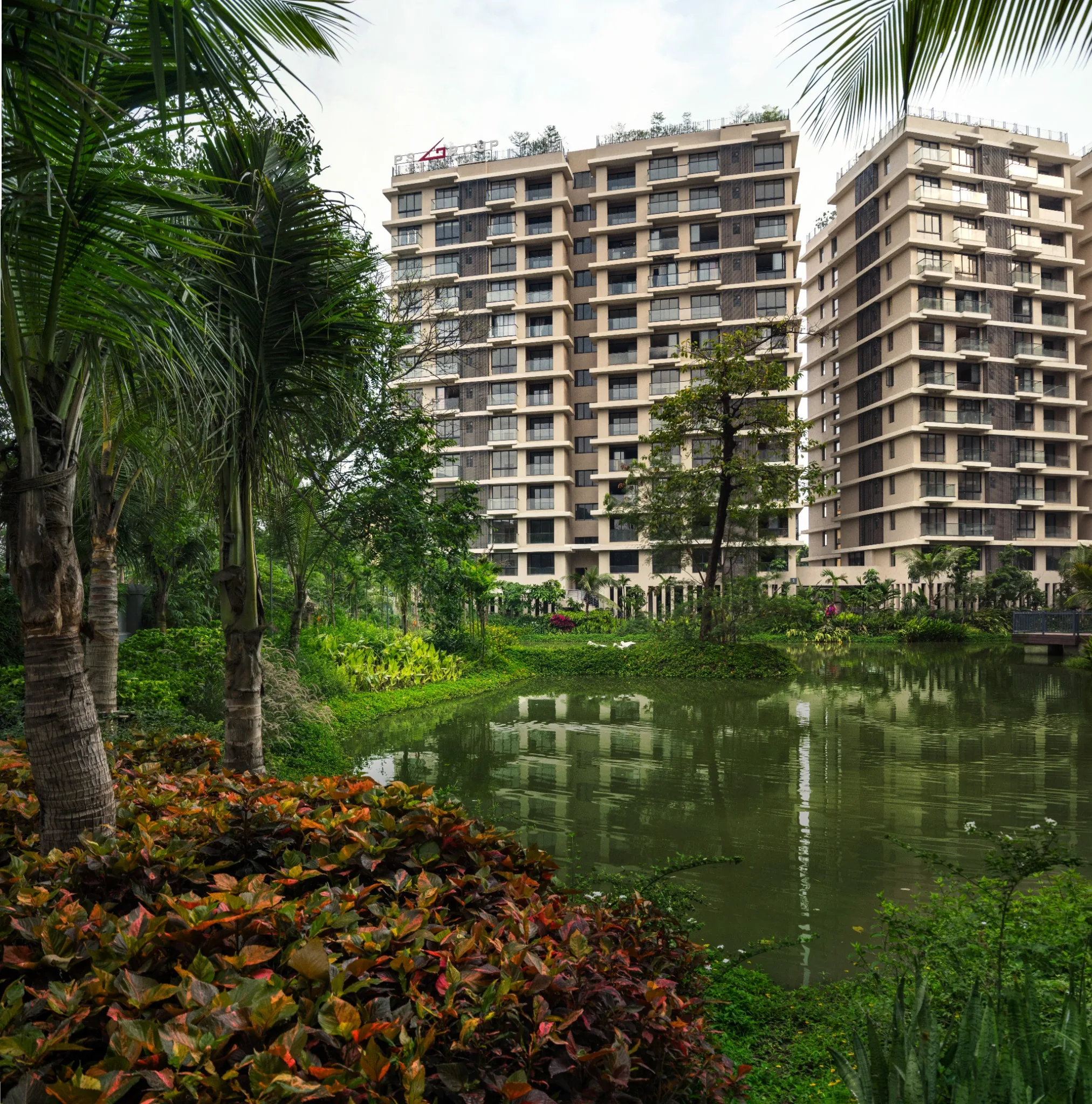 Residential blocks viewed across the planted lake at Jiva Homes