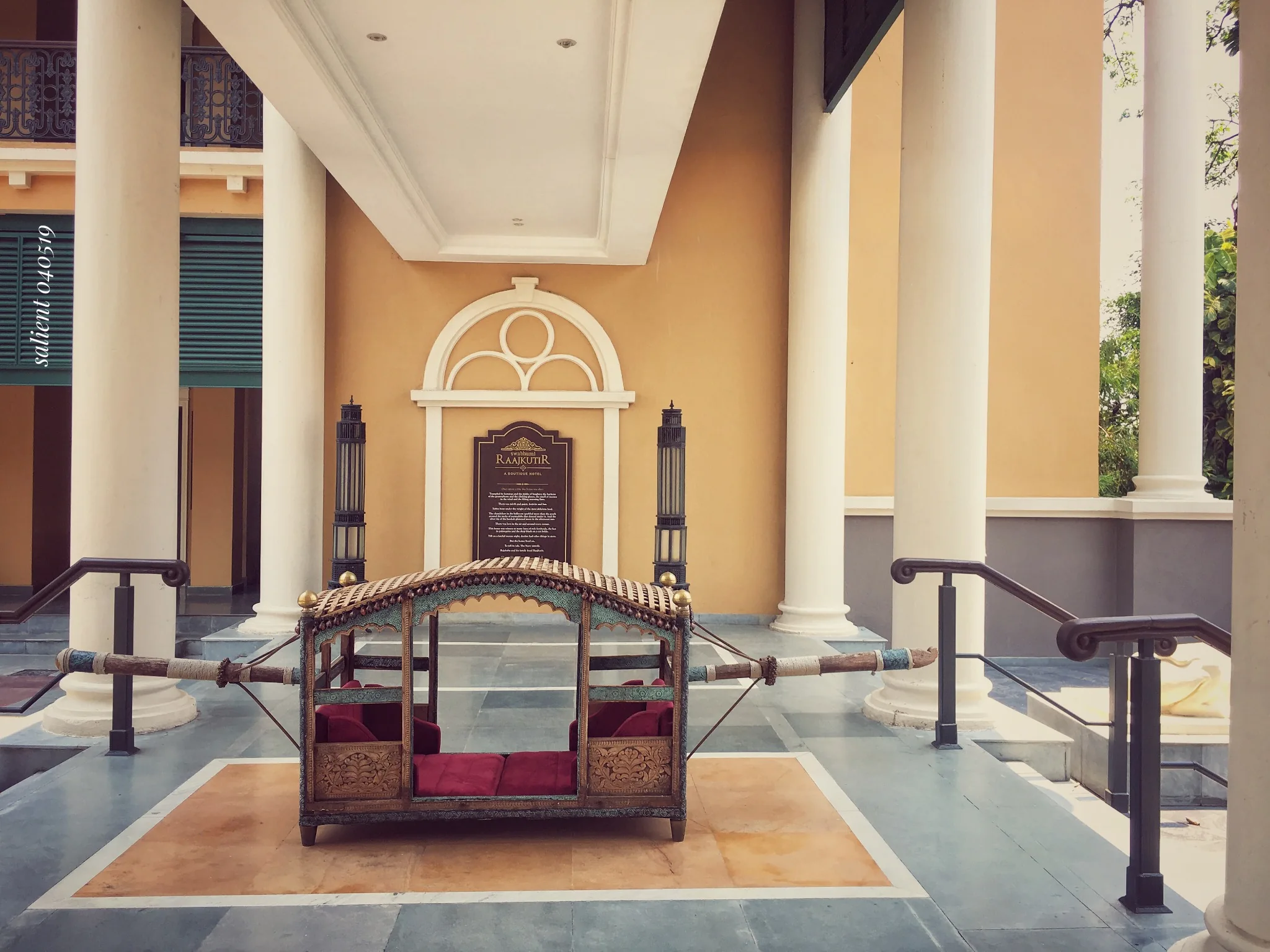 Colonnaded verandah with a traditional palanquin on display at IHCL SeleQtions – Raajkutir, Kolkata