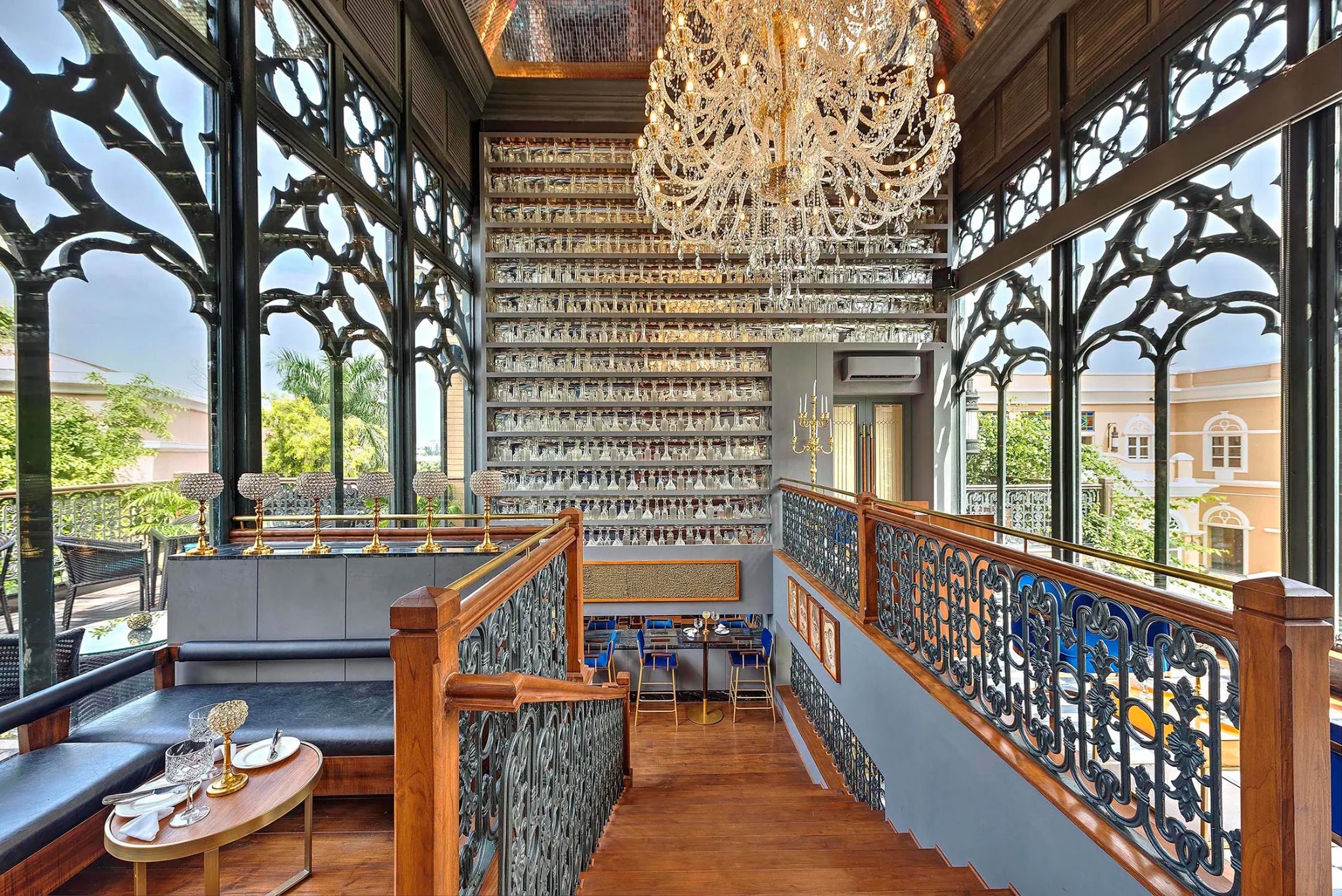 Swig stair lounge with cast-iron screens, chandeliers and views towards the courtyard, Kolkata