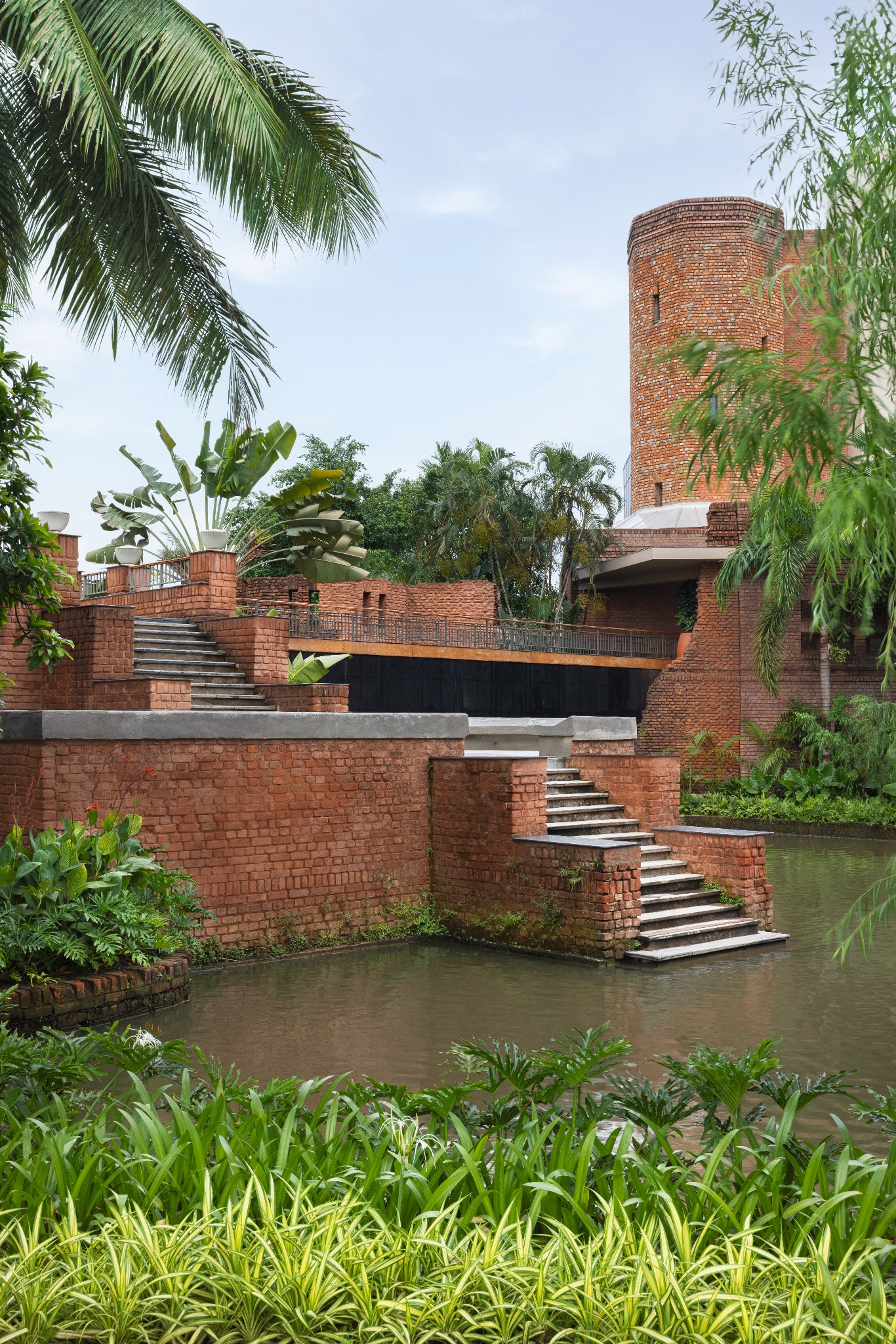 Brick terraces, steps and planted water edge